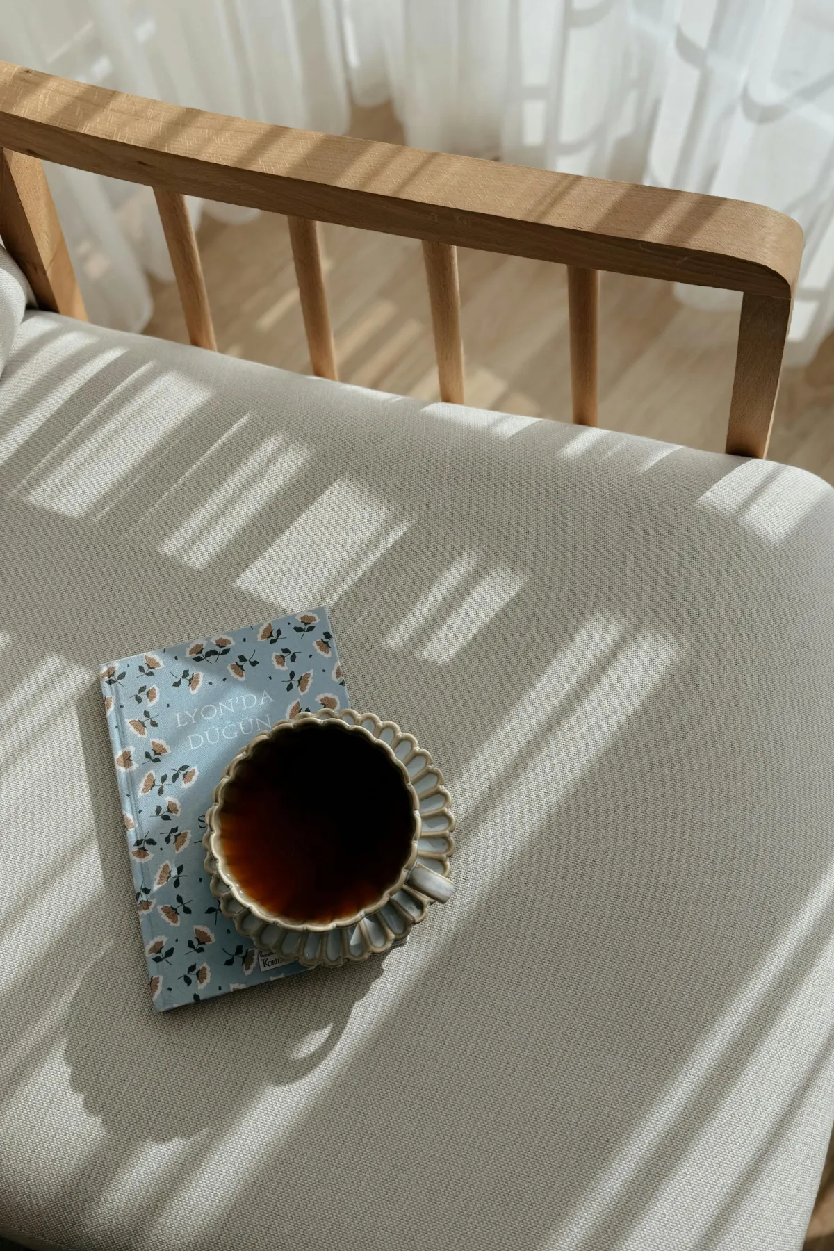 Blue, floral journal with a tea mug on top 